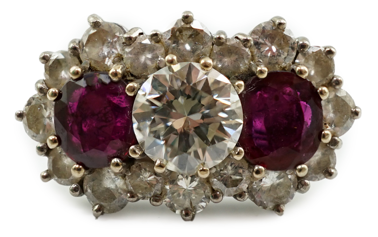 A 1970's 18ct white gold, ruby and diamond set triple cluster dress ring